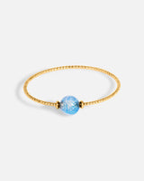 Liliflo_bijoux modulables swiss made_bracelet Milonga en simple tour_couleur or jaune avec un Murano Zenith de couleur bleu aqua avec feuille d’argent